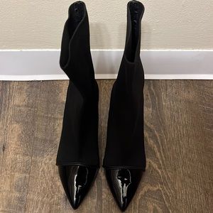 Black heeled boots with patent leather boots.